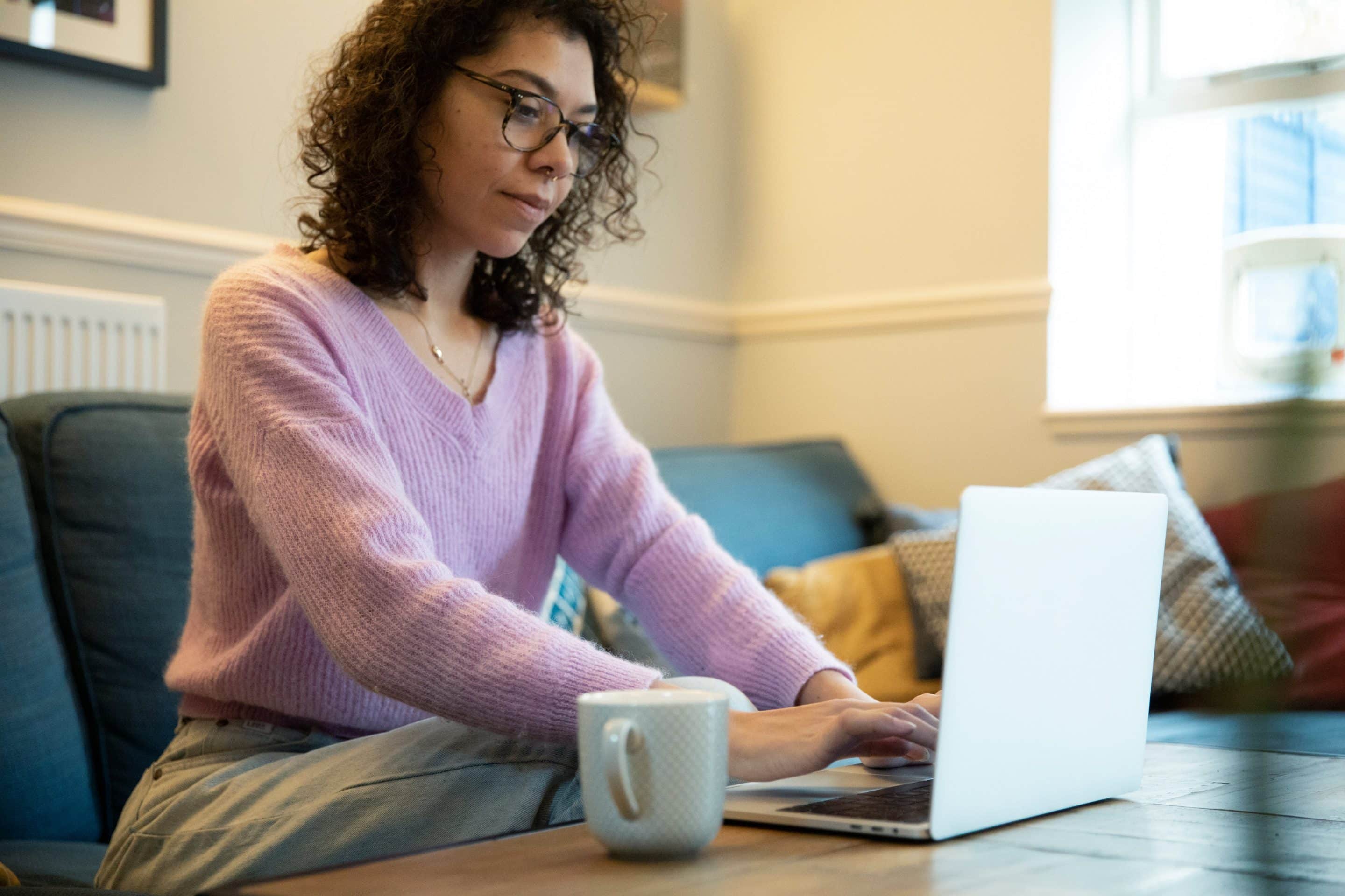 person working on laptop from couch